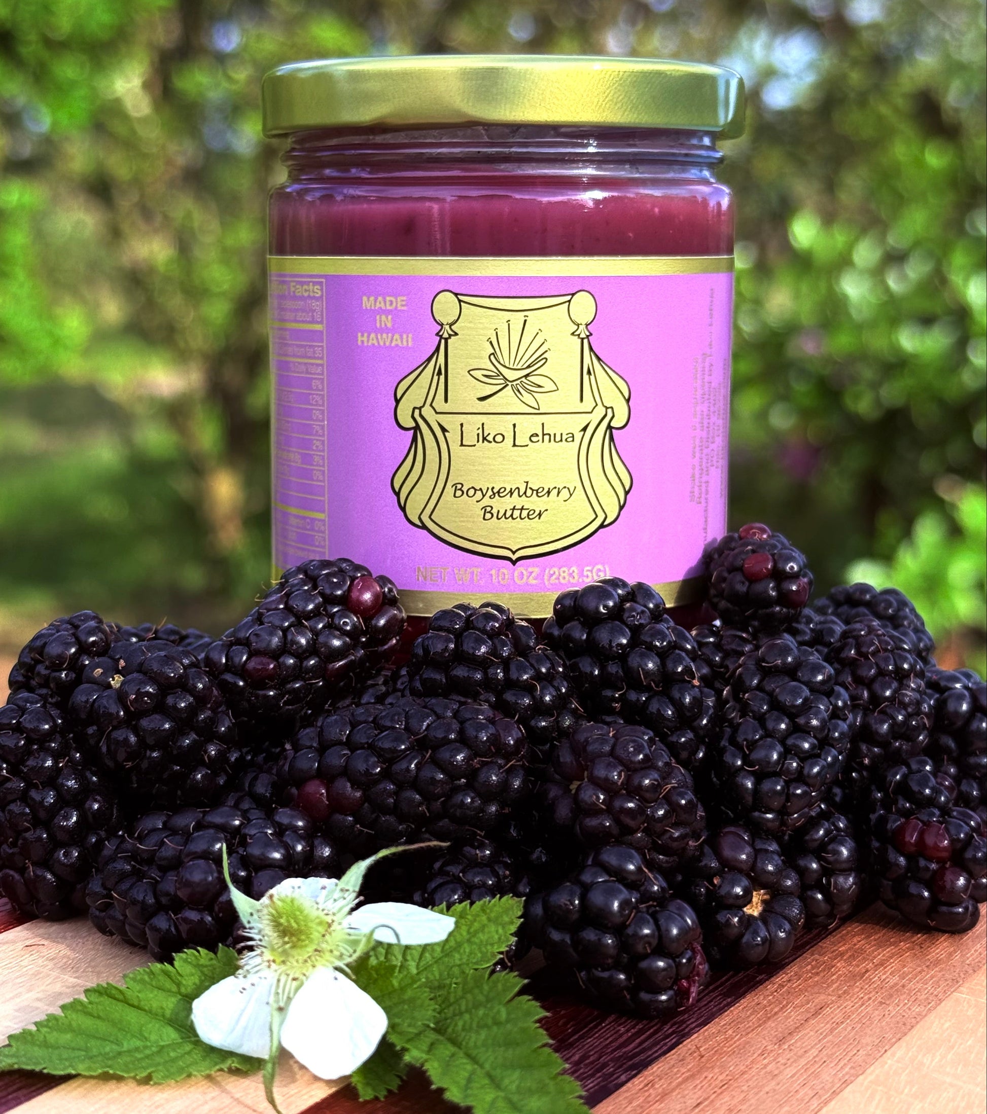 Jar of berry butter with blackberries on a wooden surface outdoors